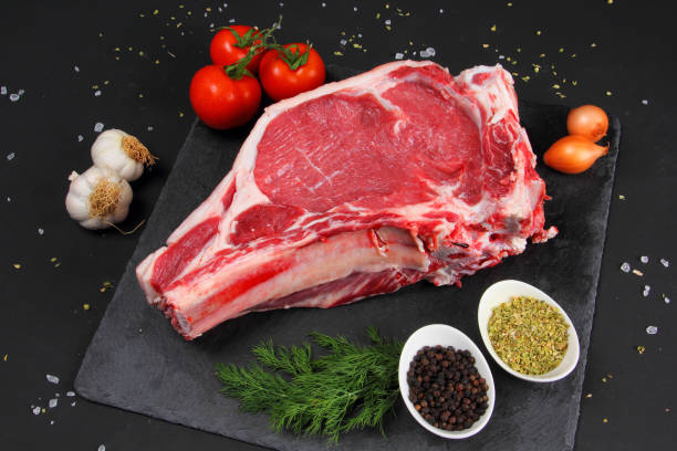 istock Raw Steak Beef on the Black Background 899234112