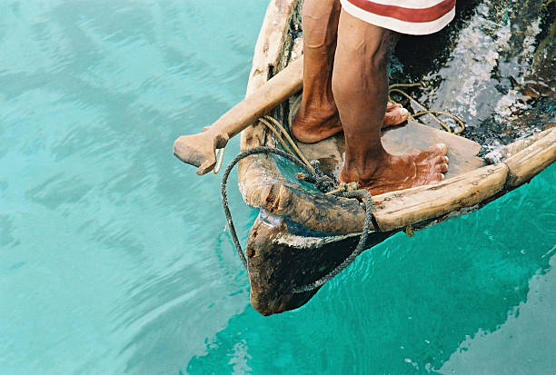 Two crossed black feets relaxing during a cruise on a boat