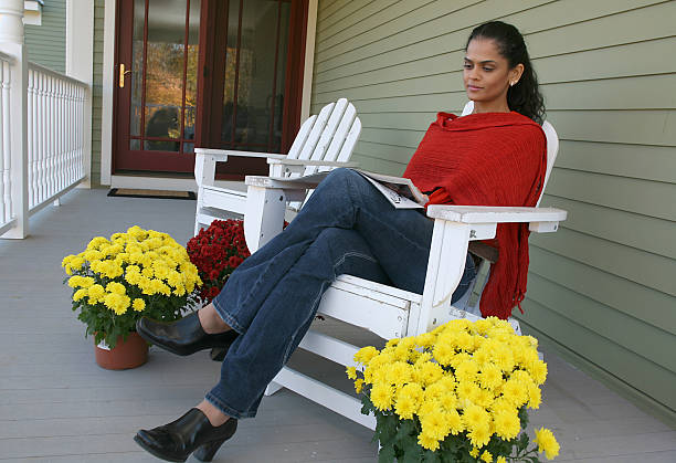 Mature Woman With Casual Attire Enjoying Coffee Outdoors.