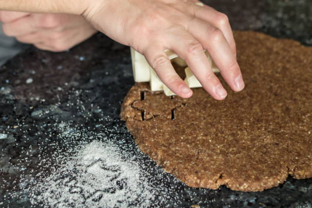 istock hand cut out the cinnamon stars on christmas dough 899247460