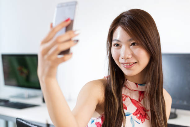 istock young asian woman designer using mobile phone 899259710