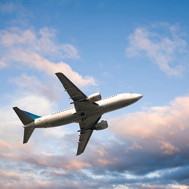 istock Passenger Jet Climbing against Evening Sky 89926248