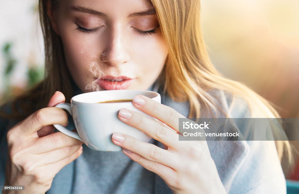 Beautiful women drink hot coffe Cafe, Winter, Women, Coffee - Drink, Sunset Coffee - Drink Stock Photo