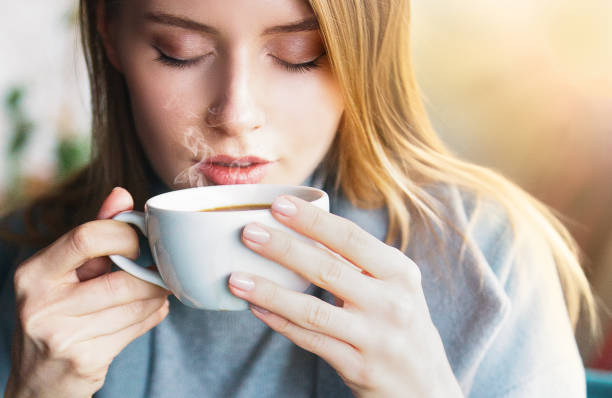 Beautiful women drink hot coffe Cafe, Winter, Women, Coffee - Drink, Sunset coffee drink stock pictures, royalty-free photos & images
