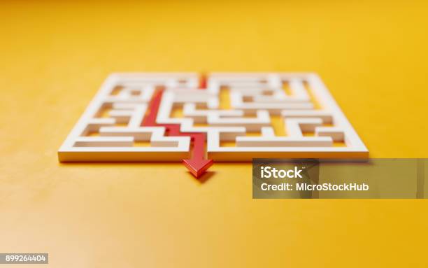 Red Path Across A White Maze On Yellow Background Solution Concept Stock Photo - Download Image Now