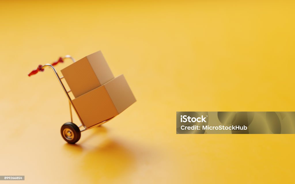 Card boxes On A Hand Truck On Yellow Background Card boxes on a hand truck on yellow background.  Horizontal composition with selective focus and copy space. Relocation Stock Photo