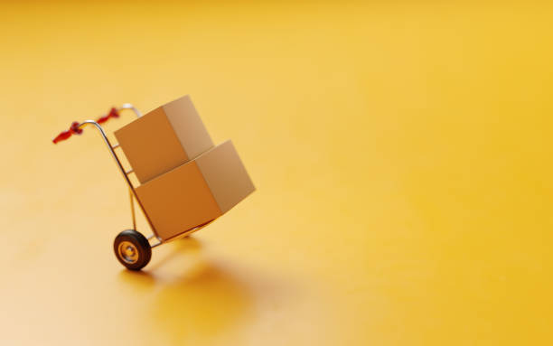 Card boxes On A Hand Truck On Yellow Background Card boxes on a hand truck on yellow background.  Horizontal composition with selective focus and copy space. free of charge photos stock pictures, royalty-free photos & images
