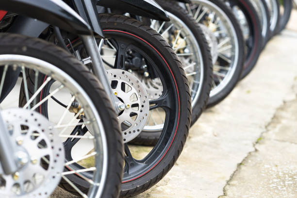 istock Motorcycles standing in the row at a store, closeup 899267984