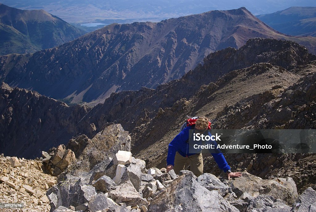 Hiking Fourteeners in Colorado Completing a 4th Class scramble on a 14,361 foot mountain Above Stock Photo