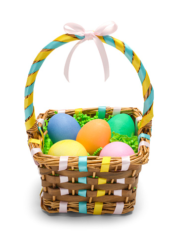 Small basket with painted Easter eggs and geraniums on a white background.