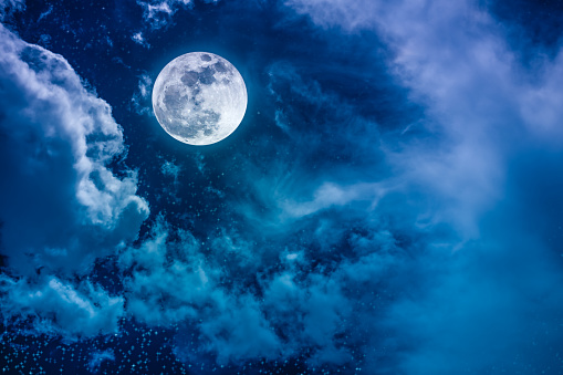 Beautiful vivid cloudscape with many stars. Night sky with bright full moon and cloudy, serenity blue nature background. Outdoor at nighttime with moonlight. The moon taken with my own camera.
