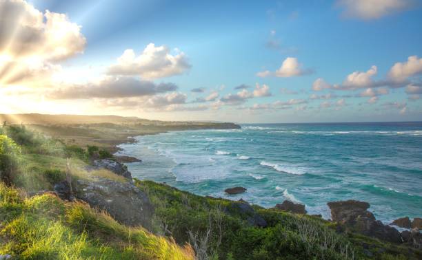Sunset at the east coast of Barbados with rugged coastline stock photo