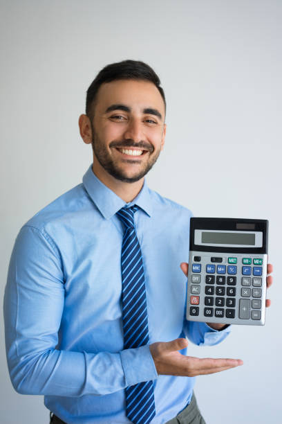 istock Happy Young Business Man Showing Calculator 899284772