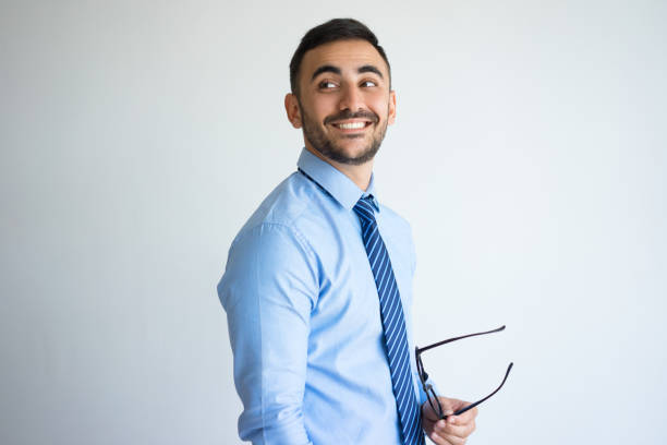 istock Relaxed Handsome Business Man Holding Glasses 899284804