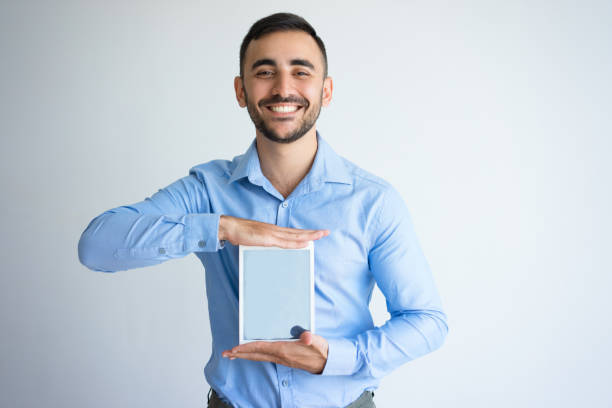 istock Smiling Handsome Business Man Presenting Tablet 899284834