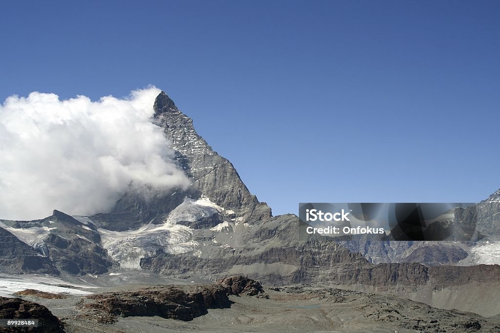 Matterhorn Mountain Summit View from Zermatt The Matterhorn, seen from Zermatt with a big cloud behind Blue Stock Photo