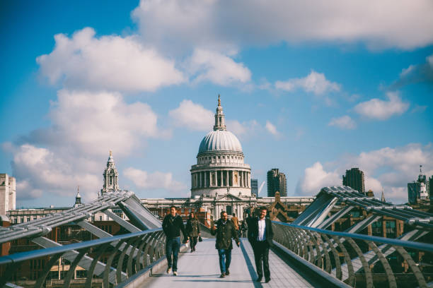 St. Pauls cathedral dome from across the river Thames London,UK April 27th 2016: People walking on the Millennium bridge in London,UK. St.Paul Cathedral can be seen in the background. bankside photos stock pictures, royalty-free photos & images