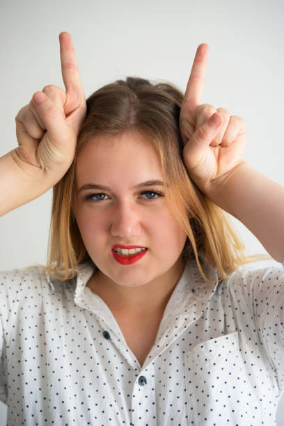 istock Brazen young woman showing horns with fingers 899287468