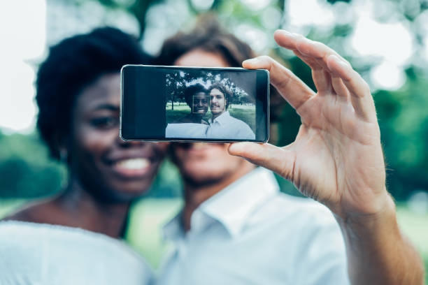 istock Smiling mix-raced couple taking selfie with phone 899288876