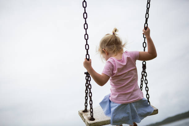 istock Girl on a wooden swing 899296968