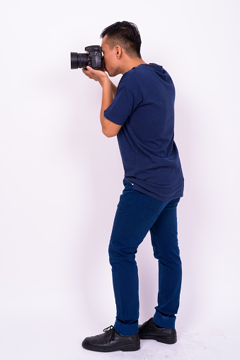 Studio Shot Of Asian Man Against White Background