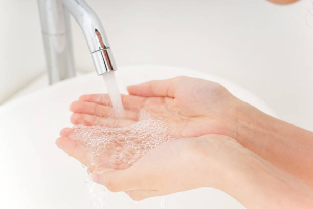 istock Young woman washing her face 899301108