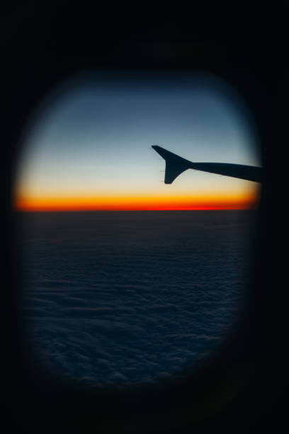 istock Close up Airplane window with airplane wing 899301264