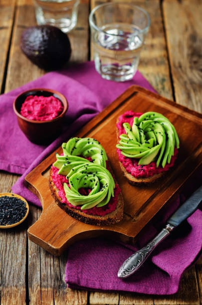 Healthy beet hummus avocado rye breakfast sandwiches