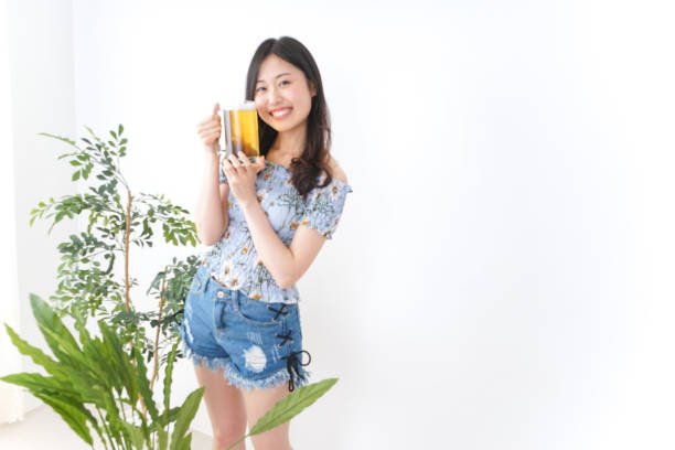 istock Young woman cracking a beer in beer garden 899304872