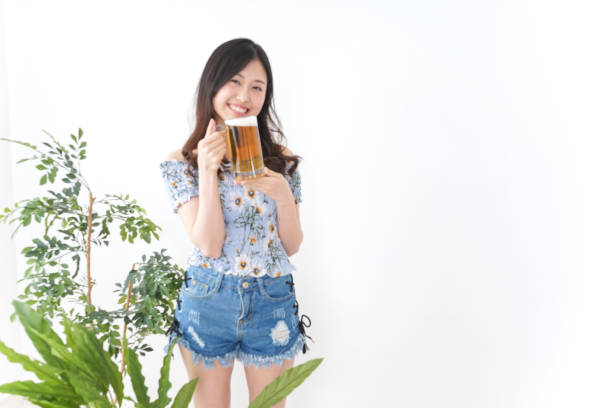 Young woman cracking a beer in beer garden