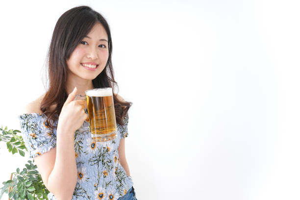 Young woman cracking a beer in beer garden