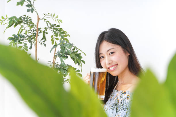 Young woman cracking a beer in beer garden