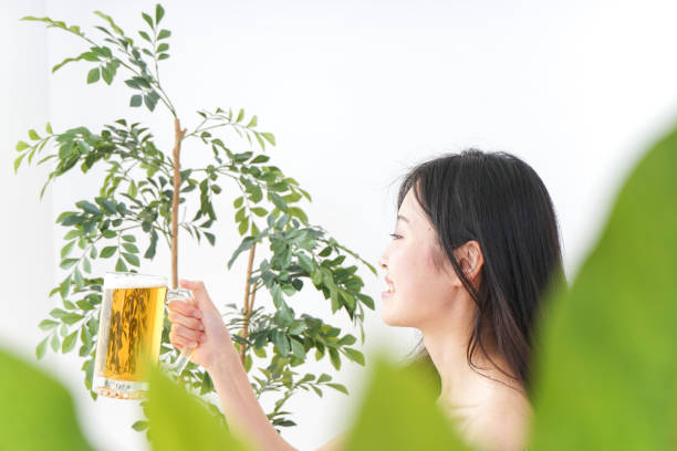 Young woman cracking a beer in beer garden