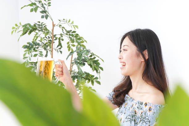 Young woman cracking a beer in beer garden
