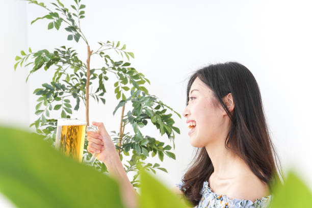 Young woman cracking a beer in beer garden