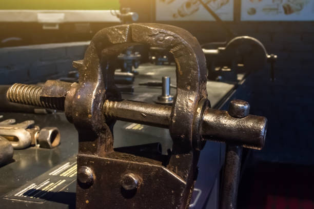 istock Old metal vise on the table tool. 899312388