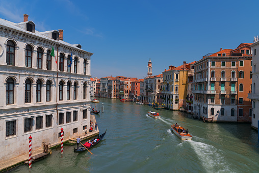 VENICE, ITALY – MAY 23, 2017: Magnificent daily view of Gondola with classical buildings along the famous Grand canal in Venice, Italy