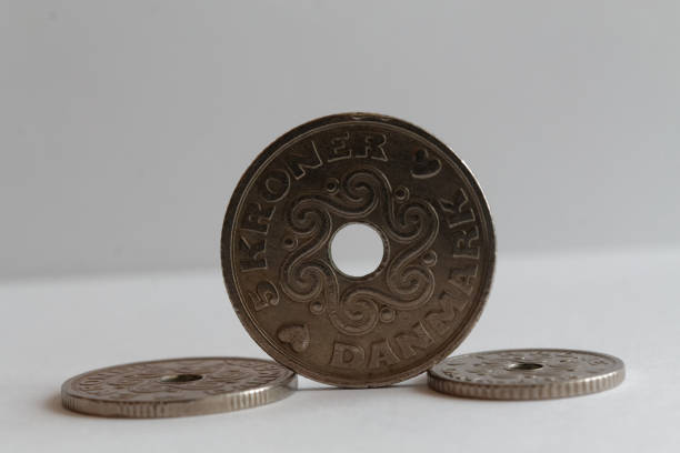 Three Denmark coins, front coin denomination is five krone (crown) lie on isolated white background - back side Three Denmark coins lie on isolated white background Front coin Denomination is 5 krone (crown) - back side elefant stock pictures, royalty-free photos & images