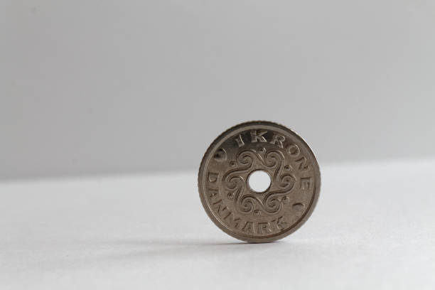 Denmark coin denomination is one krone (crown) lie on isolated white background - back side One Denmark coin lie on isolated white background Denomination is 1 krone (crown) - back side elefant stock pictures, royalty-free photos & images