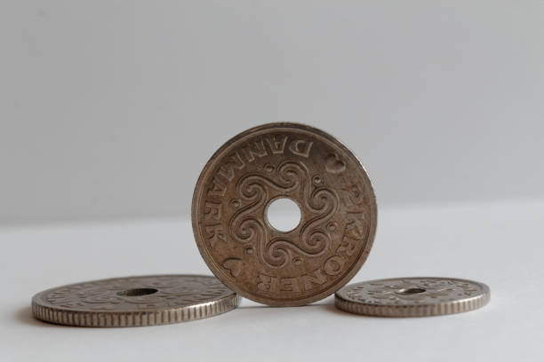 istock Three Denmark coins, front coin denomination is 2 krone (crown) lie on isolated white background - back side 899317112