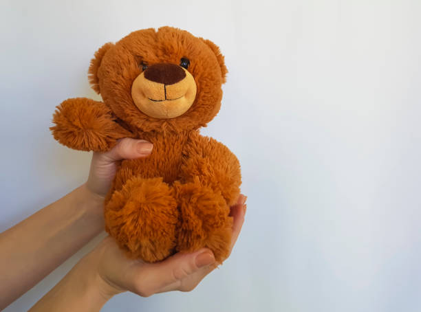 istock Hand holds a teddy bear toy isolated 899320514