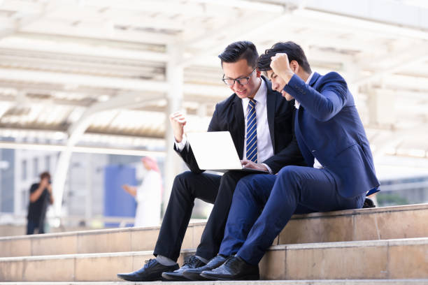 istock businessmen sitting are working on laptop 899320790