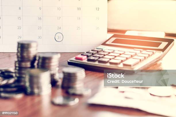 Debt Collection And Tax Season Concept With Deadline Calendar Remind Notecoinsbankscalculator On Table Stock Photo - Download Image Now