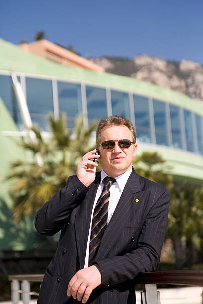 Succesful businessman with cellular in the sun stock photo