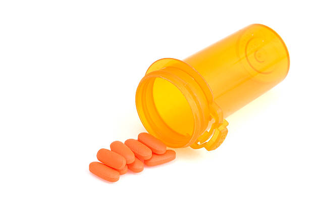 Pills and Bottle in Orange Hue stock photo