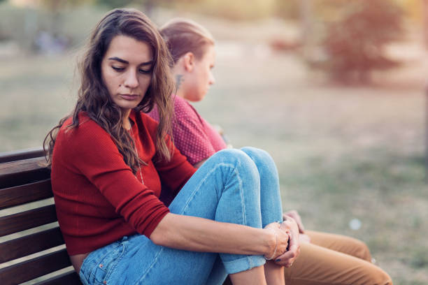 istock Women sitting sad and distant from each other 899326660