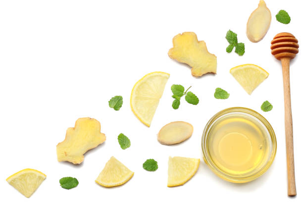 istock healthy background. sliced ginger, honey and lemon isolated on white background top view 899329272