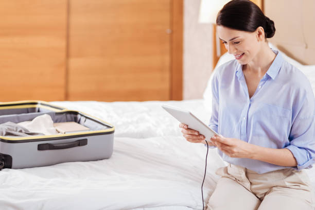 istock Brunette positive woman looking at the tablet 899331248