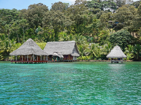 Lush tropical shore with small eco resort over the Caribbean sea in Panama, Bocas del Toro, Central America