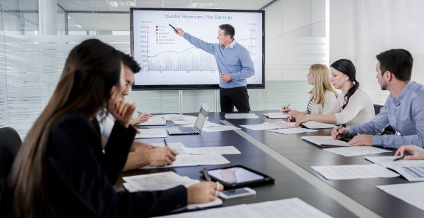 istock Man giving financial presentation to his colleagues 899339112